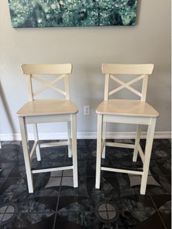 Two white solid wood chairs