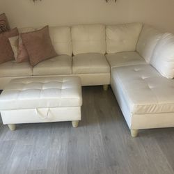 white sectional and ottoman 
