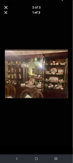 Dark wood China cabinet with a mirrored back