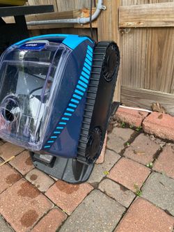 This is a Polaris Freedom cordless robotic pool cleaner with a clear filter canister.