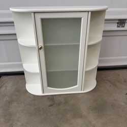 Wall cabinet with glass door.