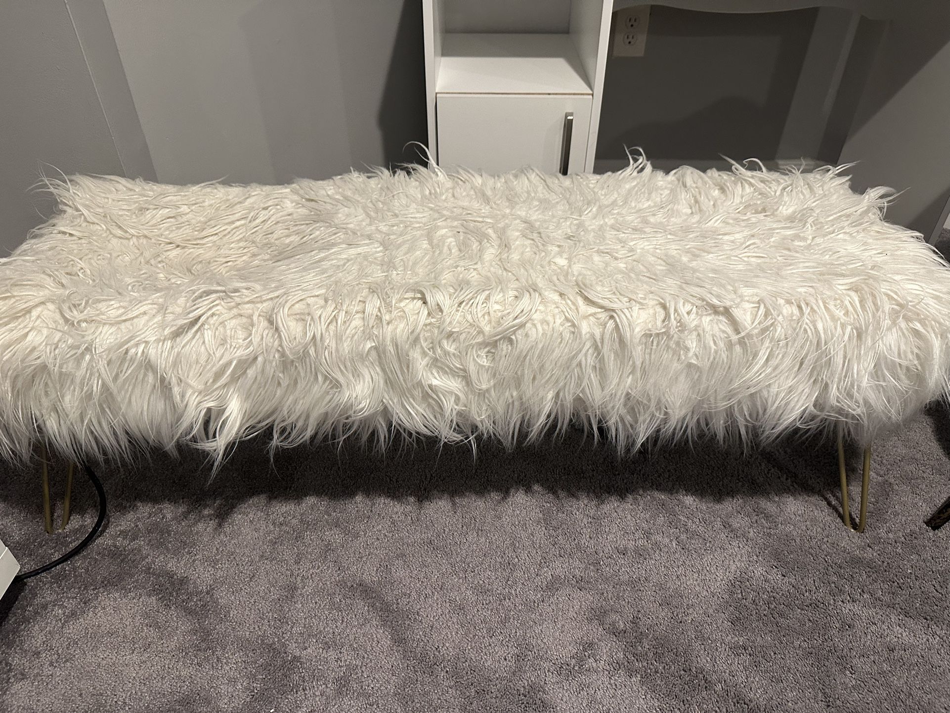 White long chair with the gold legs