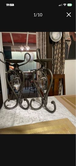 Set of two wrought iron candle holders holding glass strawberries