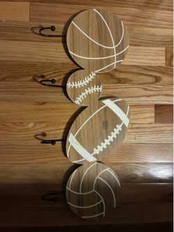 Wooden sports-themed wall hook rack featuring basketball, baseball, football, and volleyball designs.