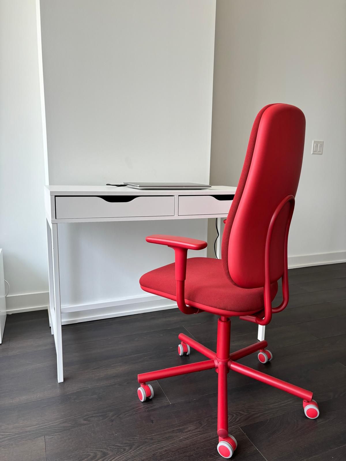 white desk and red office chair with armrests