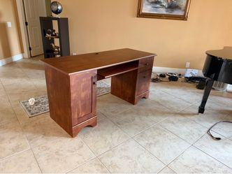 Three identical wooden desks