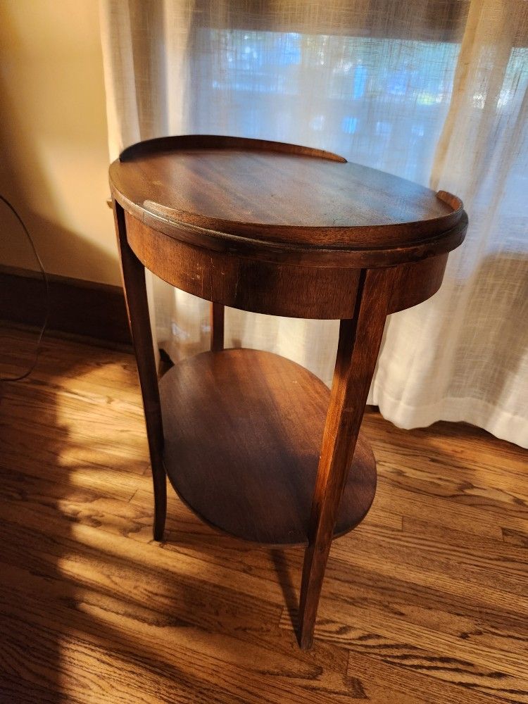 Vintage oval shaped wood table approx 17"W x 23.5"L x 26"H