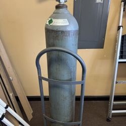 Large gas cylinder tank for sale with valve and rolling cart included.
