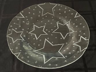 Clear glass decorative serving plate featuring an etched star pattern. 14”