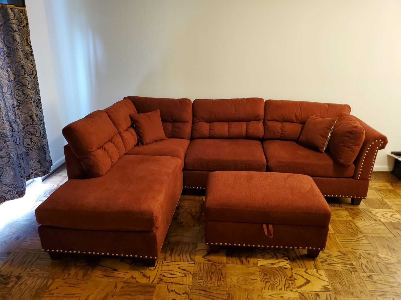 Red Velvet like Sectional Sofa with storage ottoman and 2 accent pillows.