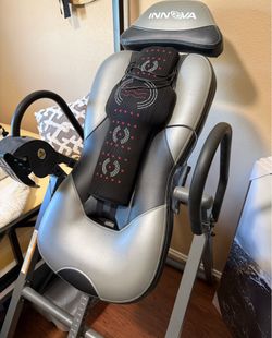 Inversion table with heat/massage pad