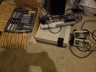 Nintendo with games. Includes two original controllers, original duckhunt zapper, and game genie.