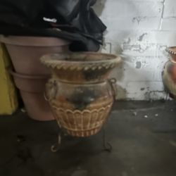 Three terracotta planters with rod iron stands