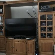 Solid wood entertainment center with lighted towers, side and bottom storage. Fits most size TVs.