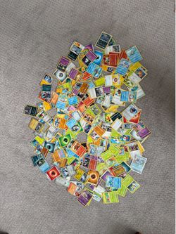 Assorted Pokémon cards and tin