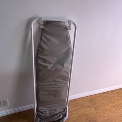 Ironing boards hangs on a door