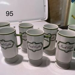 Set of (7) beautiful ceramic Irish coffee cups. Great for St. Patrick’s Day. One of the coffee cups has a paint chip on top of the handle you can see 