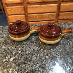 Vintage Lot Of 2 French Onion Soup Lidded Crock With Handle.  Color Brown And tan.  Preowned Excellent Condition.  I don’t think I ever used them.  