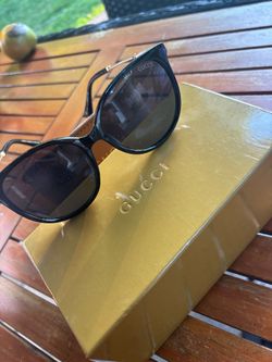 Black Gucci sunglasses with case.