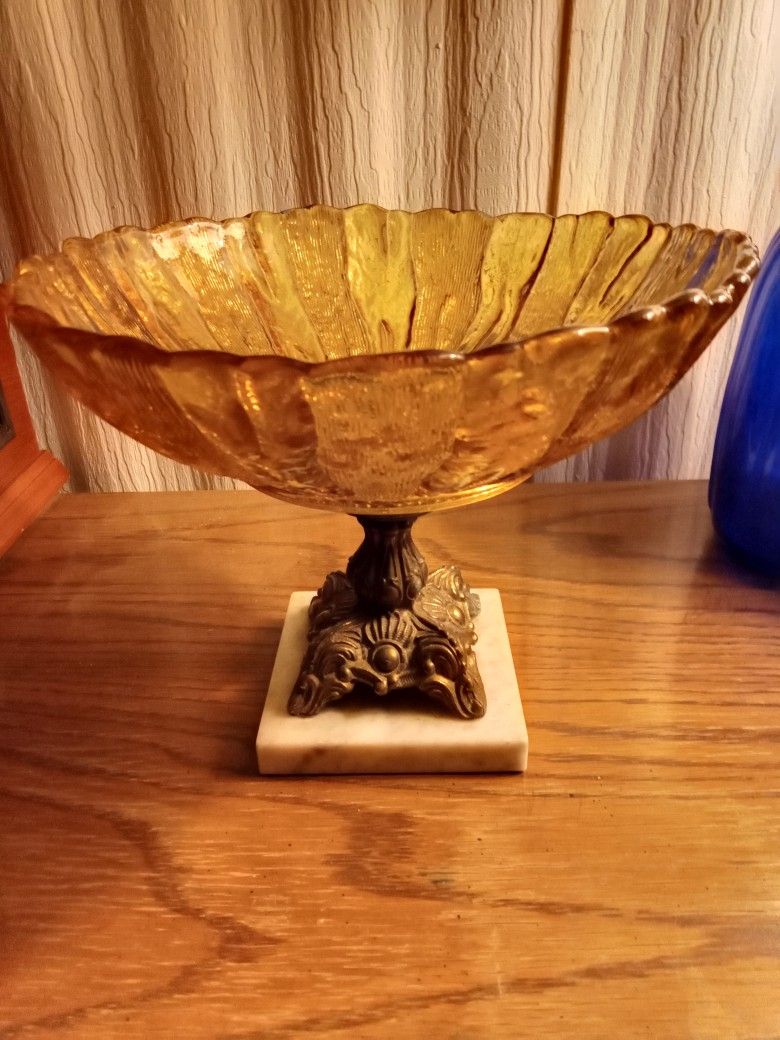 Vintage Hollywood Regency Bronze, Marble, Amber Glass Candy Dish
10 1/2" Diameter x 8 1/4" T
Marble base 4 3/4" W x 3/4" D
Marble base is included