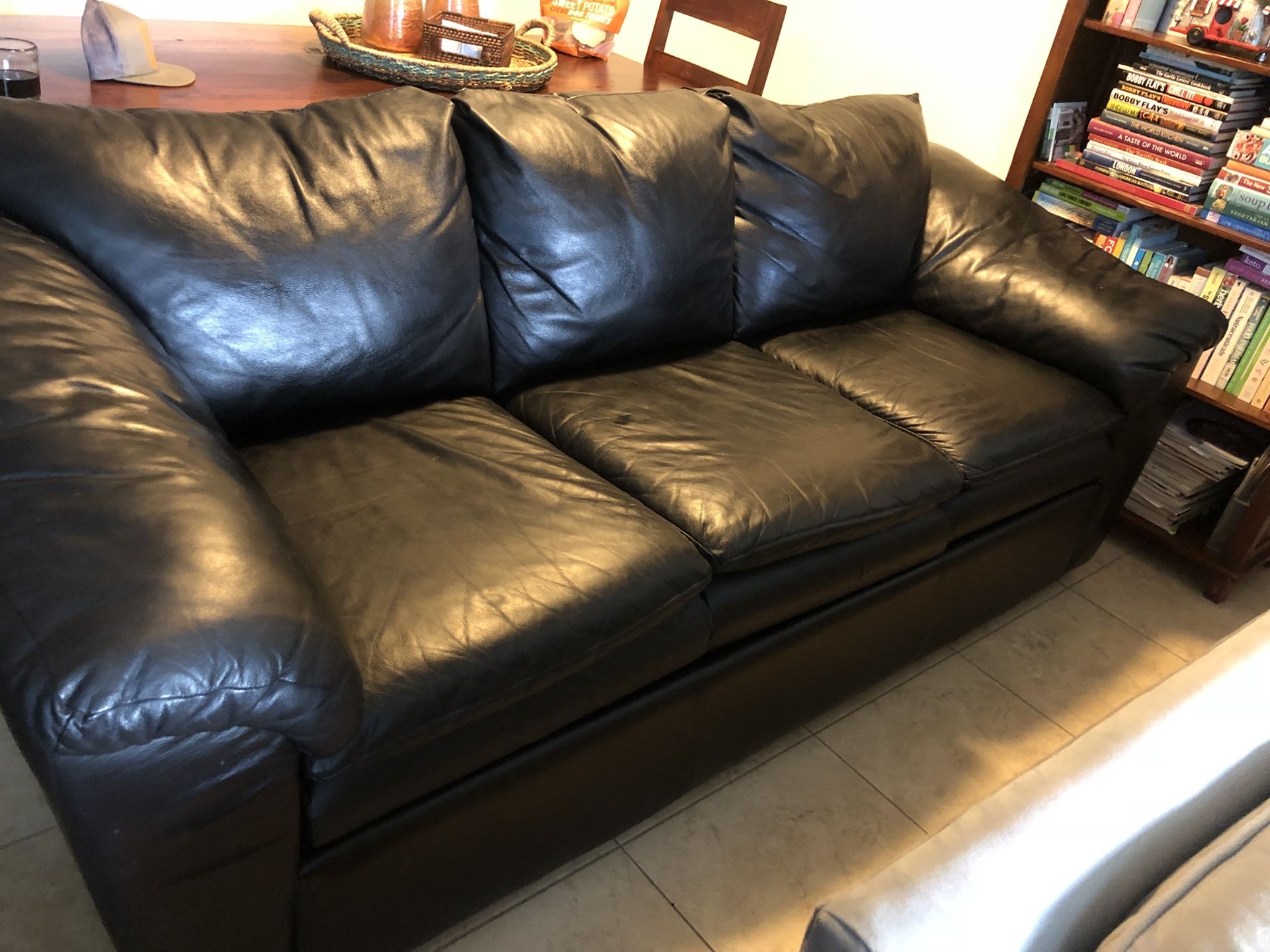 black leather sofa, love seat and ottoman