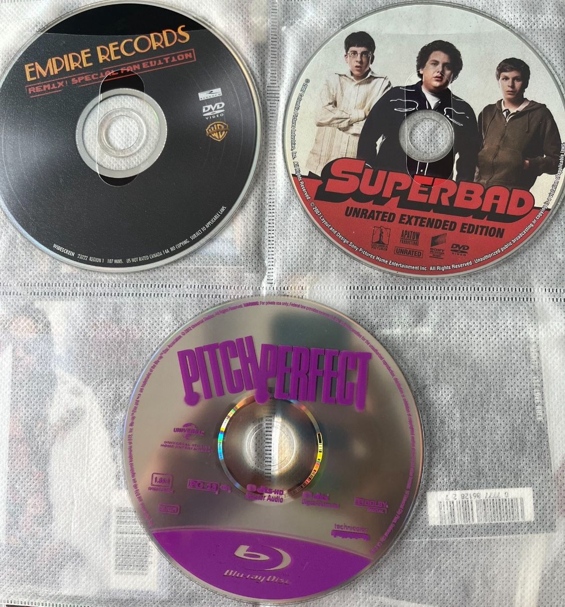 Superbad, Pitch Perfect, Empire Records DVDs Great collection of movies. Includes 3 dvds. No plastic gem boxes. In CD sleeve. I can mix and match any