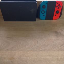Neon Blue and Neon Red Joy-Cons and its dock. 