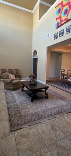 Rug, swivel rocker, coffe table