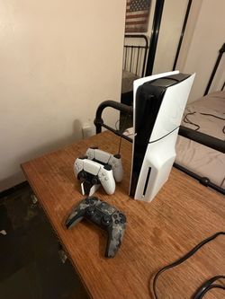 PlayStation 5, 3 controllers, and charging station