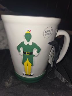 Rae Dunn Elf "World's Best Cup of Coffee" Ceramic Mug featuring a raised, double-sided graphic of Buddy the Elf.