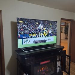 Chimney Freestanding Electric Fireplace with 65" LG smart TV and Visio surround sound home theatre