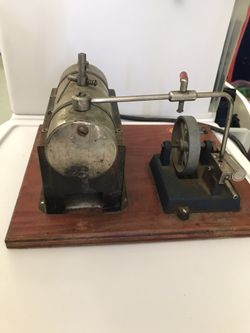 a vintage toy steam engine manufactured by Jensen Manufacturing Co. 