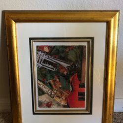Framed picture of guitar, trumpet, and saxophone 18”x14.5”