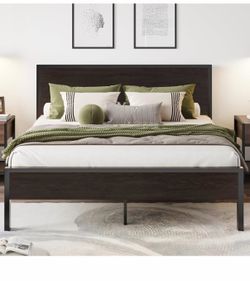 Full size bed frame. Metal frame with decorative wood headboard and footboard.
