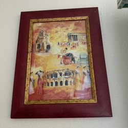 The framed picture appears to be a collage-style artwork depicting iconic scenes of Rome, prominently featuring the Colosseum