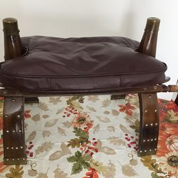 Vintage, camel saddle, footstool, brass, studs and caps on legs and horn, dark red leather cushion