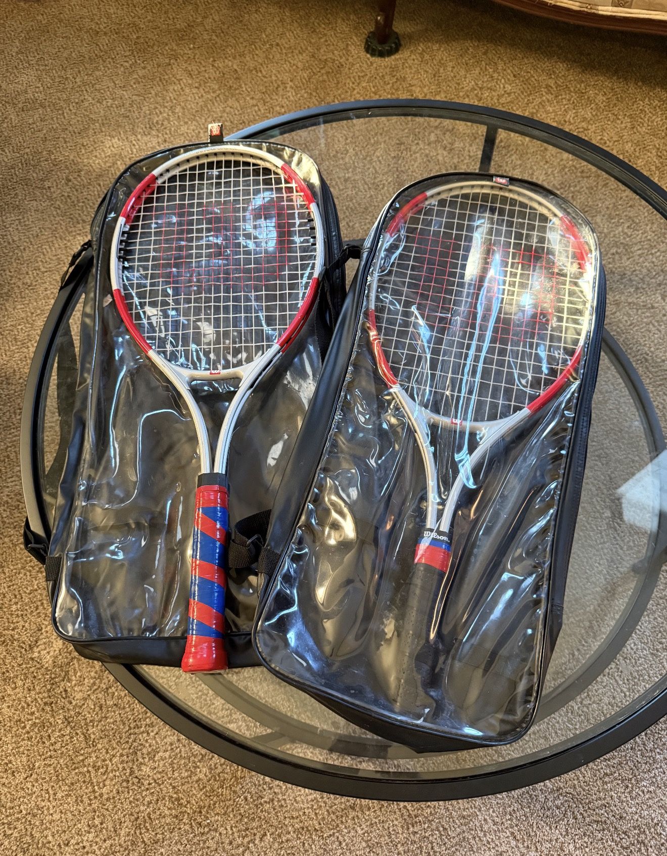 Set of two Wilson tennis rackets with a matching Wilson dual-compartment carry bag.