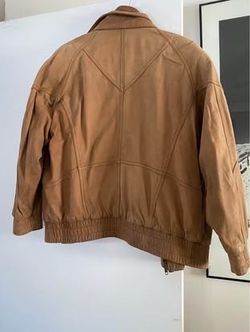 Large waist length brown leather jacket
