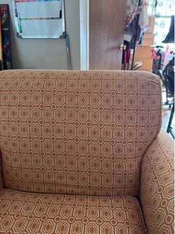 Patterned orange/white overstuffed chair