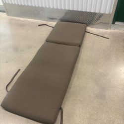 Light brown thick lounge chair cushion with zipper for washing. 24 “ wide , 74 “ long, 4” thick