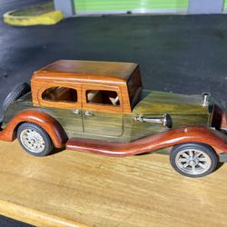 handmade wooden model of a vintage or antique car. 