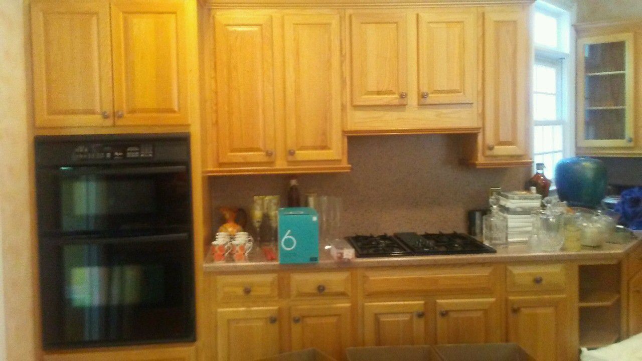 Solid oak kitchen cabinets double oven stove and dishwasher and granite