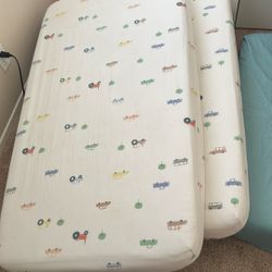 Two Grago Crib Mattresses With Protectors For Free