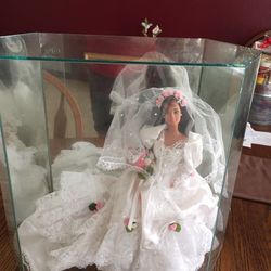 Collectible bride doll in glass case with mirrored back