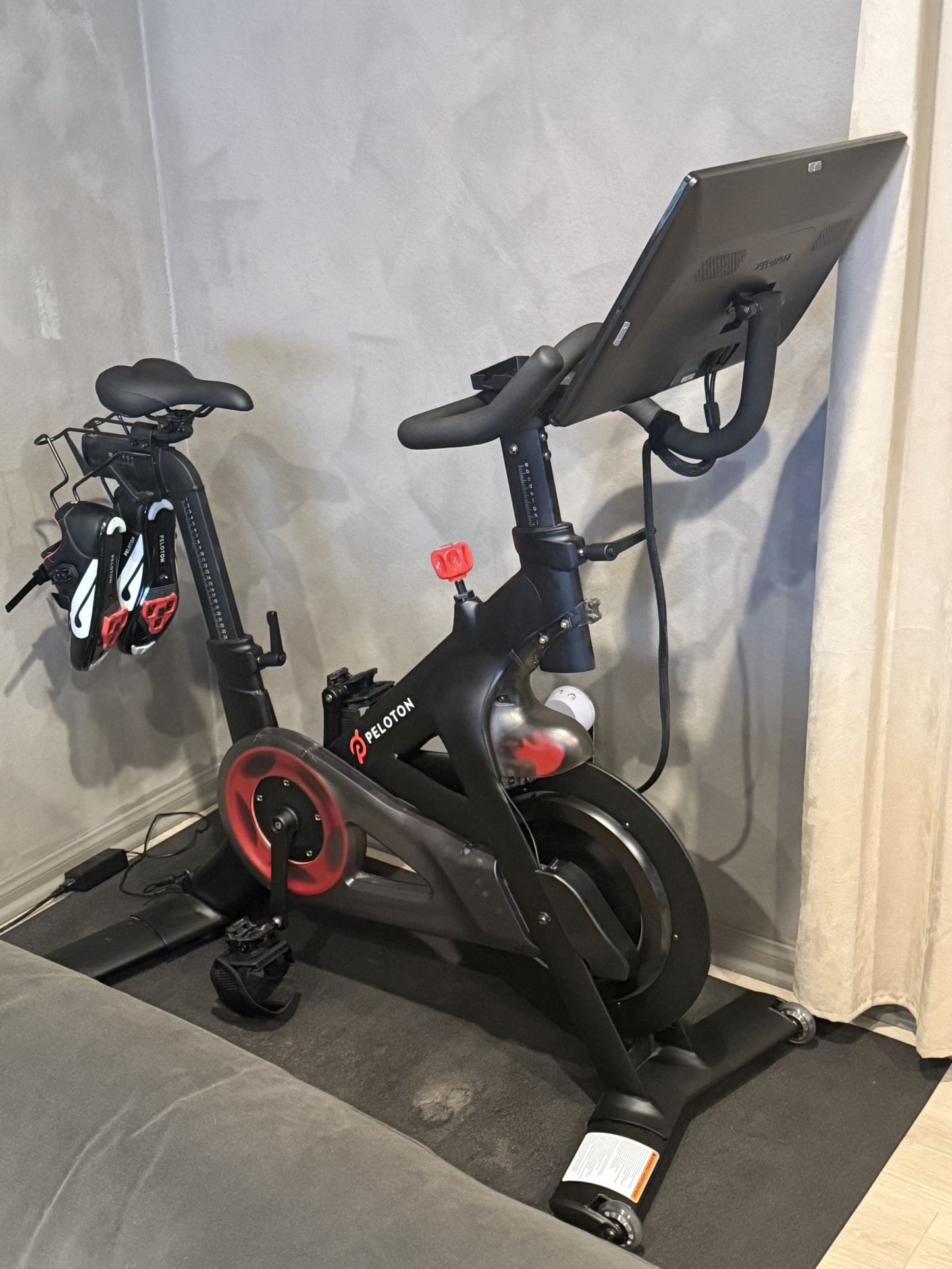 Peloton Bike - Includes 4lbs Weights, Shoes, Mat And Aftermarket Pedals And Cellphone Tray