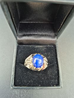 Mens Custom 18k rolled over 14k white gold with a 4ct. Flawless Star Sapphire surrounded by 1 1/4 ct. Diamonds. One of a kind