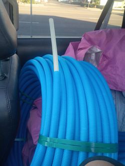 The blue item in the image is a roll of corrugated tubing, likely used as an electrical conduit or a plumbing/drainage pipe.