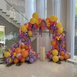Tropical Theme Balloon Backdrop with Mix of Silk and Real Flowers and a Cake Stand