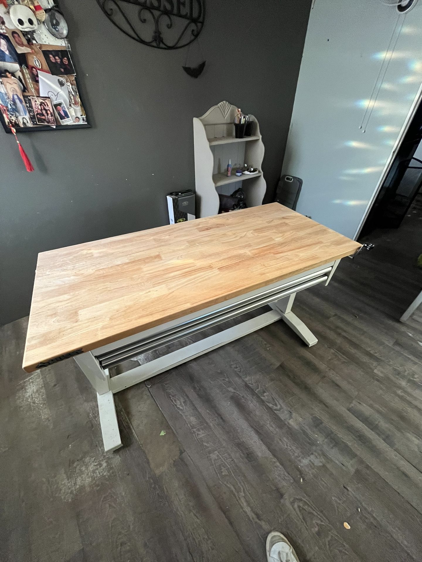 This is a Husky 52-inch Adjustable Height Work Table with 2 drawers. It features a solid wood top that is 1.2 inches thick