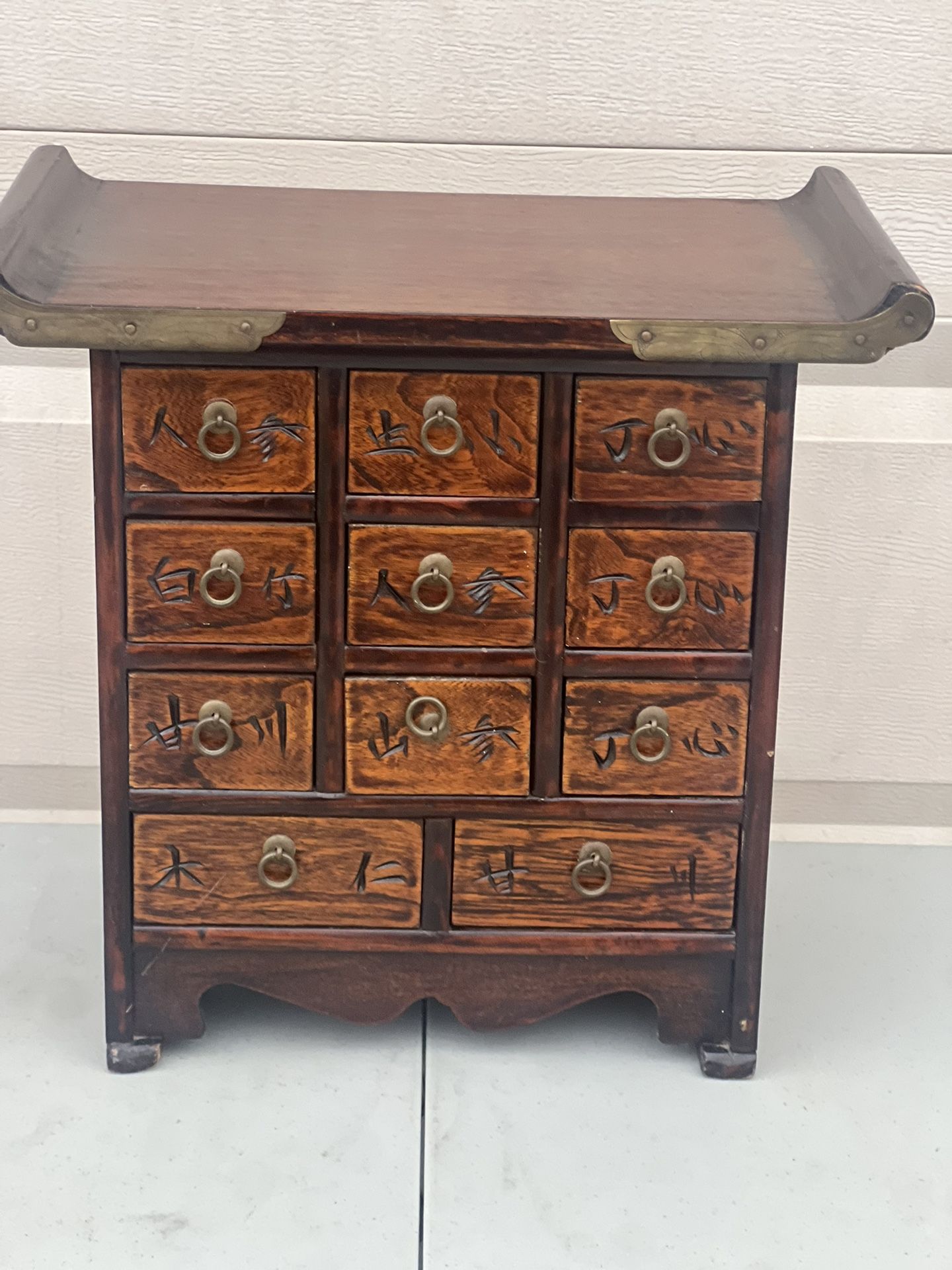 Asian Korea Wooden Brass Eleven Drawer Apothecary Chest/ Jewelry Trinket Box. Used in good condition with minor cosmetic blemishes. These blemishes ar